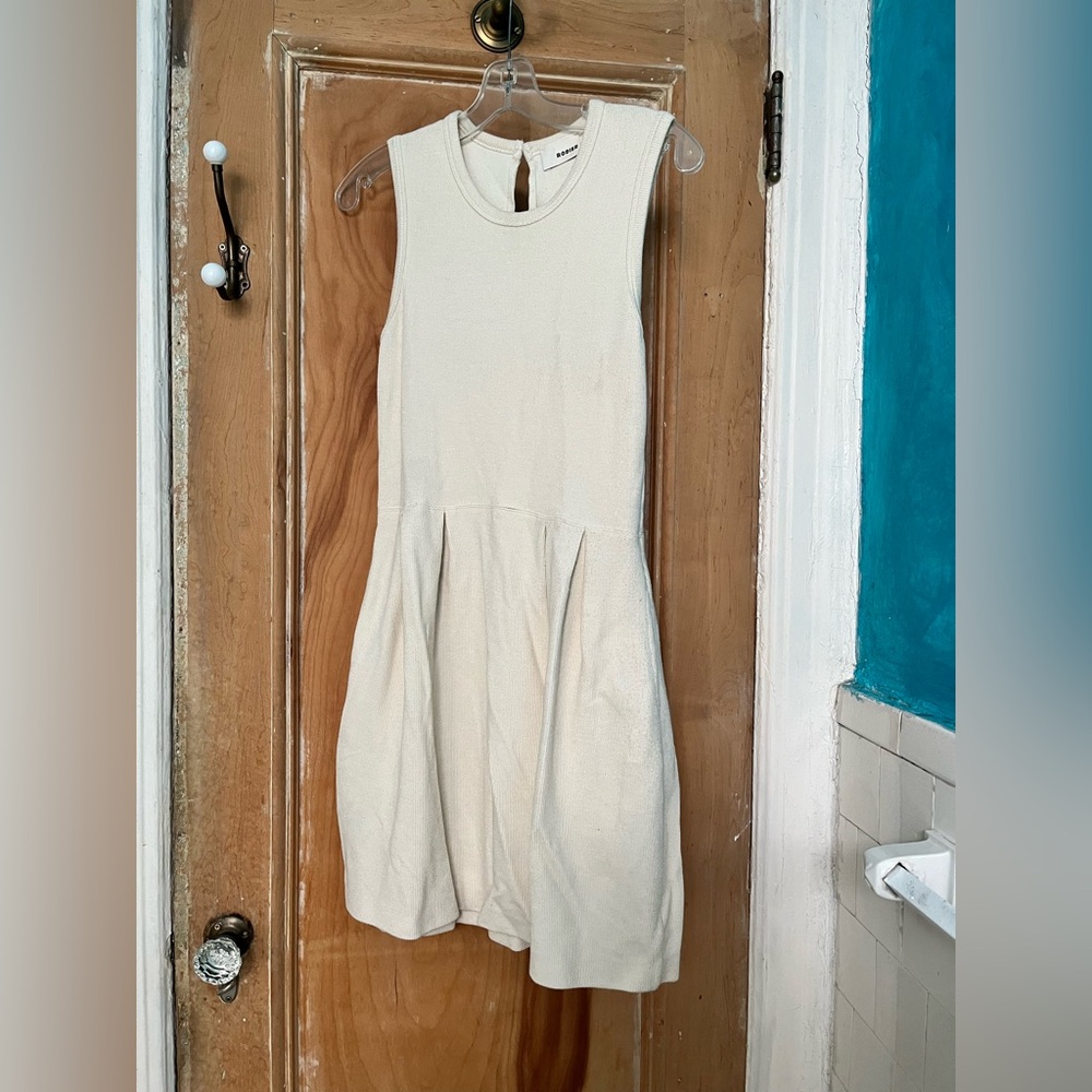 Creamy knit sleeveless dress. 
Keyhole back.
Slight wear near pocket.
Parisian.